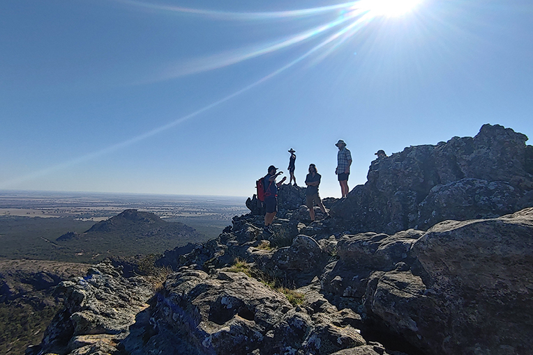 A group of people standing on top of a mountain.